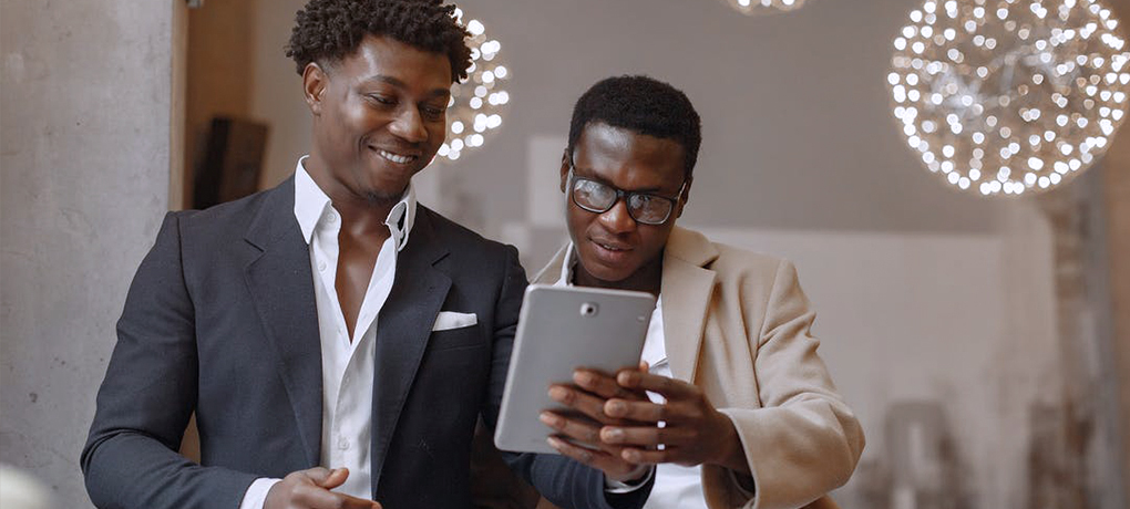 two men using tablet