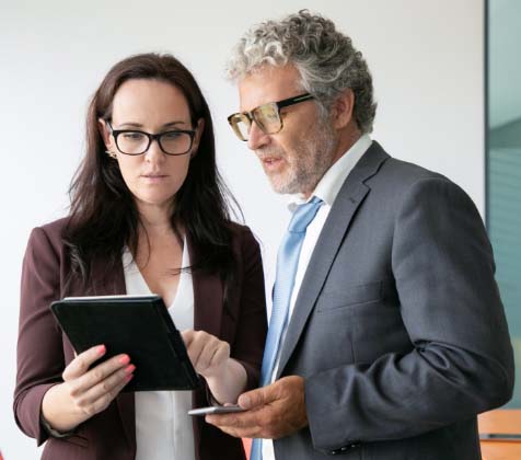 Secretary talking with an Executive regarding a document and action item in Convene Secretary talking with an Executive regarding a document and action item in Convene