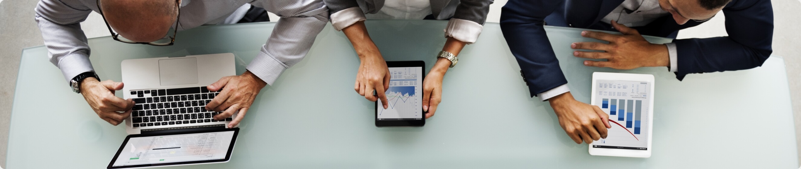 Three executives meticulously analyzing data Three executives meticulously analyzing data