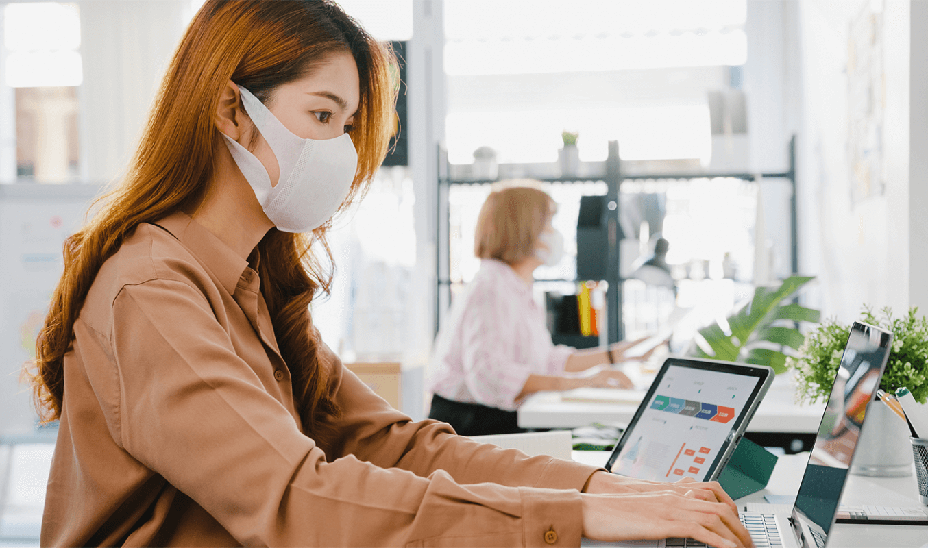 An employee working in a hybrid workplace setup