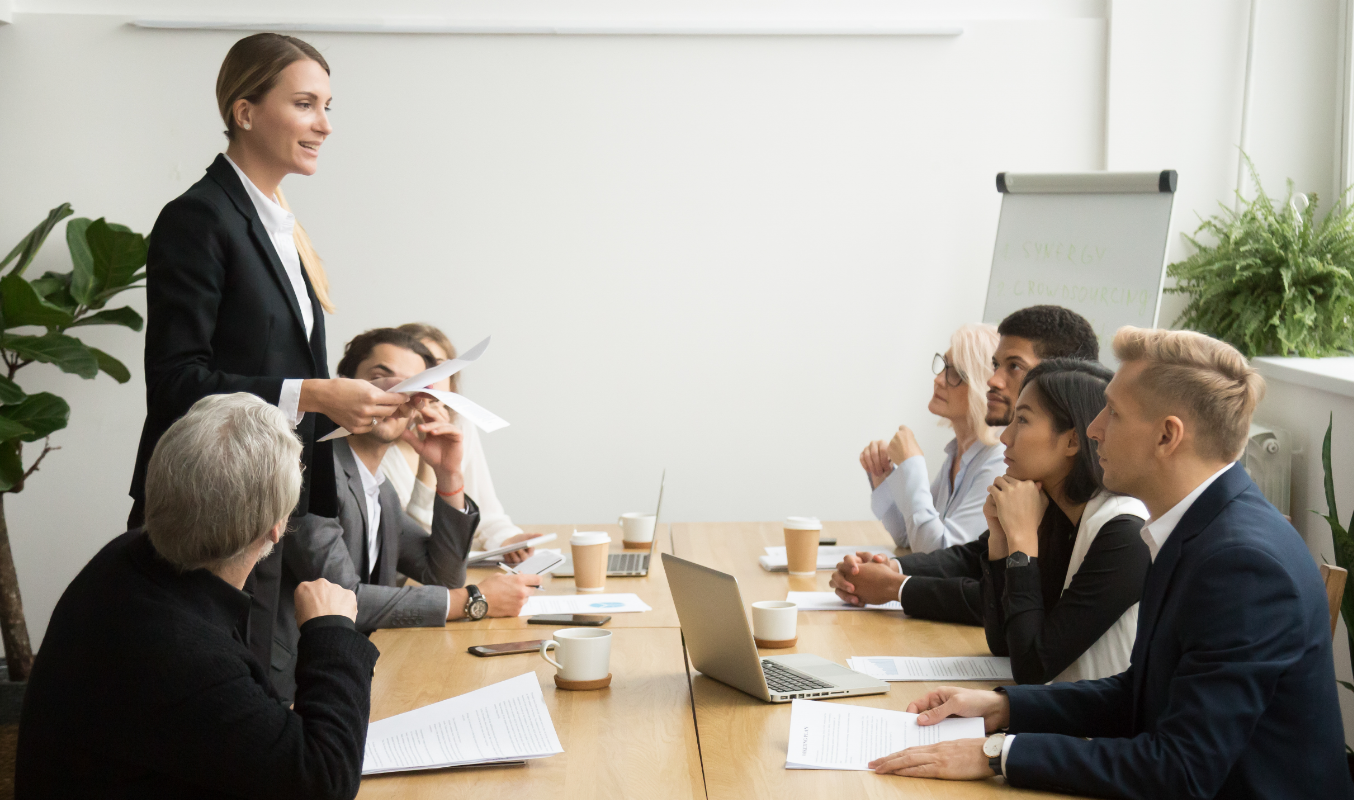 A female employee presenting her ideas during a meeting in a diverse workplace